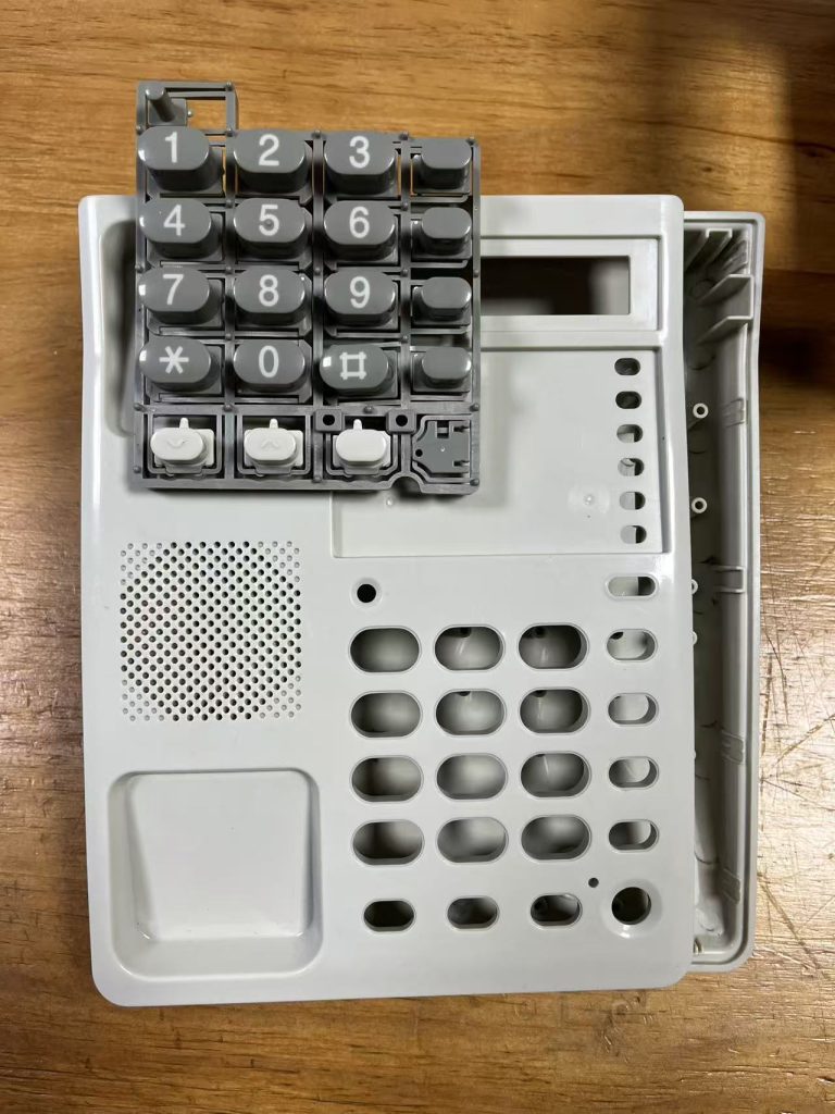 Two-shot injection molding for telephone keypads
